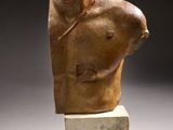 sculpture of a man ' s torso on a marble block