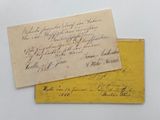 two old envelopes with writing on them sitting on a table