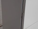 a white refrigerator in the corner of a room