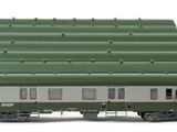 four green train cars sitting next to each other on a white surface