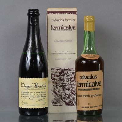 two bottles of wine sitting on a table next to a box of wine
