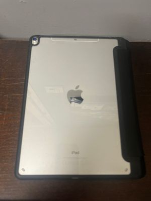 an apple ipad sitting on a table next to a wall