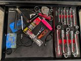 many tools in a tool box on the floor