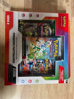 the box is open on a wooden table with a pokemon game