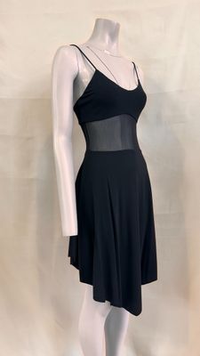 a mannequin wearing a black dress on a mannequin stand