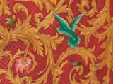two birds that are flying in the air near a red wall