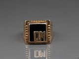 an image of a gold ring with the letter dm on it