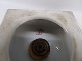 a chocolate donut in the middle of a toilet bowl