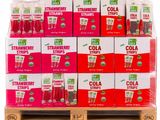 a stack of boxes of cola straws sitting on top of a wooden pallet