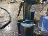 a close up of a small air gun on a workbench