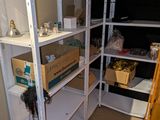 a white shelving in the corner of a room