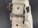 a close up of a white purse with a metal clasp