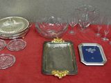 a red table with a red table cloth and silver trays and glasses