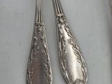 two spoons and a fork sitting on a table