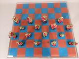 a blue and red checkered board with small figurines on it