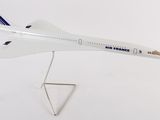 an airplane model on a stand on a white surface
