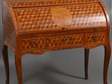 an antique writing desk with a checkered design on the top