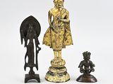 three bronze figurines of buddhas and a statue of an elephant