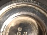 a close up of a silver plate with a picture of people on it