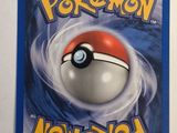 a close up of a pokemon card on a white surface