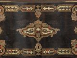 a black box with gold and red decorations on it