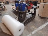 a large roll of paper sitting on a table in a warehouse