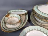 a lot of plates and bowls that are on a table