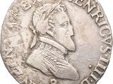 a close up of a coin with a man ' s head on it