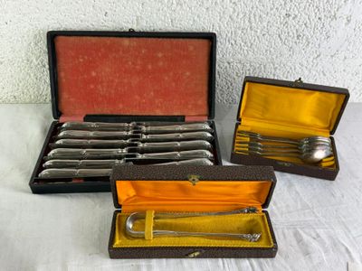 three silverware items in a case on a table