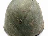 a green helmet with holes on it on a white surface
