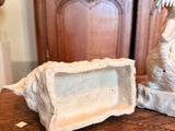 two statues of a dragon and a box on a table