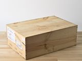 a wooden box sitting on a wooden floor