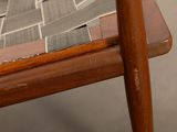 a close up of a wooden chair with a mosaic design on it