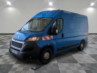 the blue van is parked on a checkered floor in the garage