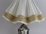 a lamp that is sitting on a table next to a lamp shade