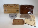 three bags and a purse sitting on a table