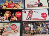 a lot of coca cola signs on the table