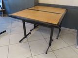 a table that has a wooden top and metal legs