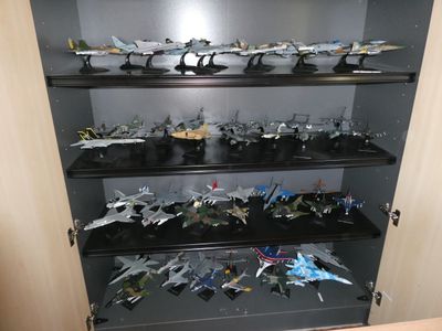 beaucoup d'avions miniatures sur les étagères de la vitrine