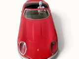 a red toy car with a man sitting in the driver ' s seat