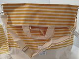 a yellow and white striped bag sitting on a counter