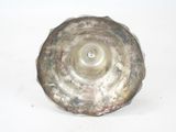 a silver object that is sitting on a white surface