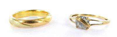 two gold rings with a stone in the middle and a stone in the middle