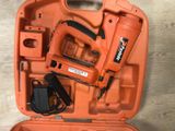 an orange tool case with a stapler, stapler, and stapler in it