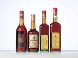 three bottles of liquor are lined up on a white surface