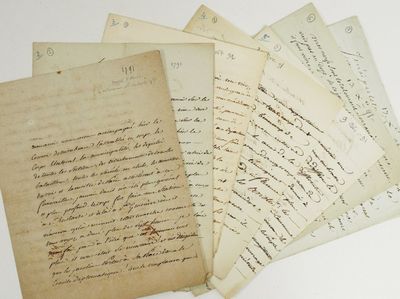 several old letters are stacked on top of each other on a table
