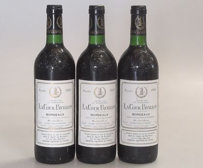 three bottles of wine sitting next to each other on a table