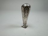 a silver vase that is sitting on a table