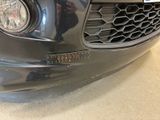 a close up of a car ' s front bumper with a number plate on it
