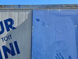 a blue door with a sign on it in front of a building